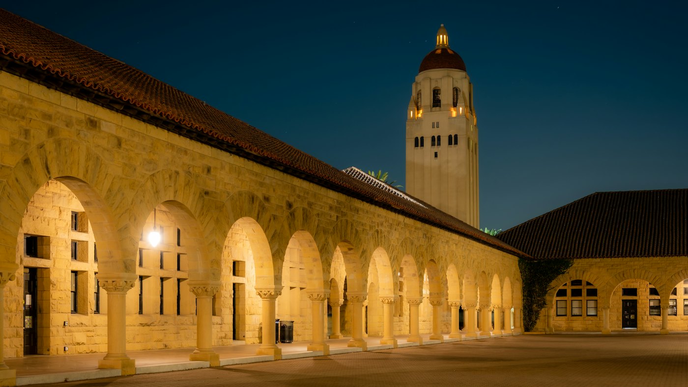 Stanford’s Main Quad arcade and Hoover Tower at dusk.